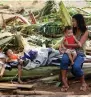  ?? AFP ?? A mother sits with her children on fallen banana trees in Barangay San Mateo Borongan in eastern Samar on Sunday, after Tropical Depression Kai-Tak blew through the area. —