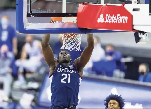  ?? John Peterson / Associated Press ?? UConn’s Adama Sanogo dunks against Creighton.