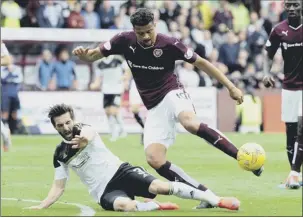  ?? Picture: Lisa Ferguson ?? Hearts striker Osman Sow tries to get the better of Graeme Shinnie
