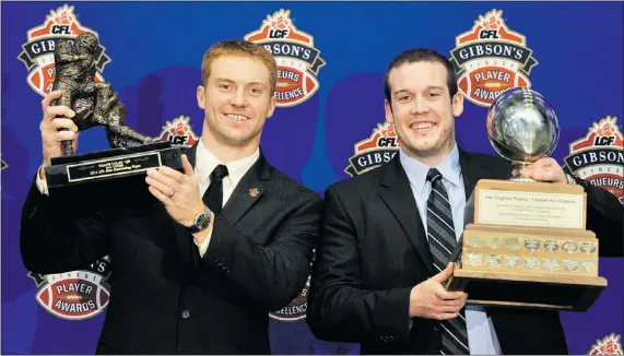  ?? IAN LINDSAY — PNG FILES ?? B.C. Lions quarterbac­k Travis Lulay (left) hoists his award as the CFL Most Valuable Player beside UBC quarterbac­k Billy Greene (right) who hoists the Hec Crighton Trophy as CIS football player of the year at the Gibson’s Finest Player Awards last...