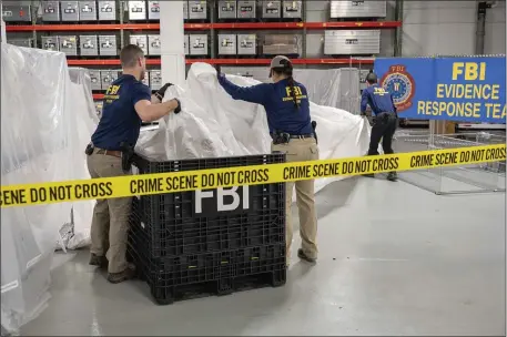  ?? FBI VIA AP, FILE ?? In this image provided by the FBI, special agents assigned to the evidence response team process material recovered from the high altitude balloon recovered off the coast of South Carolina, Feb. 9, at the FBI laboratory in Quantico, Va. The United States on Friday blackliste­d six Chinese entities it said were linked to Beijing’s aerospace programs as part of its retaliatio­n over an alleged Chinese spy balloon that traversed the country’s airspace.