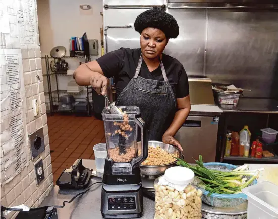  ?? Arnold Gold/Hearst Connecticu­t Media ?? Natalie Iketa prepares hummus in the kitchen at the Havenly Cafe on Temple Street in New Haven on Feb. 29.