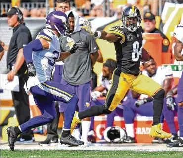  ?? JOE SARGENT / GETTY IMAGES ?? Steelers wide receiver Antonio Brown uses a stiff-arm to run for extra yards Sunday. Brown finished with five catches for 62 yards in Pittsburgh’s victory over the visiting Vikings.