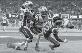  ?? ROBERT GAUTHIER/TRIBUNE NEWS SERVICE ?? Los Angeles Rams receiver Brandin Cooks (12) misses a potential touchdown pass, broken up by New England Patriots defenders Stephon Gilmore (24) and Duron Harmon (21) during the fourth quarter in Super Bowl LIII in Atlanta on Sunday.