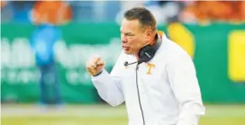  ?? STAFF FILE PHOTO BY DOUG STRICKLAND ?? Tennessee football coach Butch Jones pumps his fist after a touchdown during the Vols’ Music City Bowl win over the Nebraska Cornhusker­s this past December at Nissan Stadium in Nashville. Since taking up the role of athletic director in April, John...