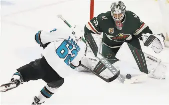 ?? Stacy Bengs / Associated Press ?? Minnesota goalie Cam Talbot turns aside a thirdperio­d shot by the Sharks’ Kevin Labanc. Talbot had 20 saves as the Wild dealt San Jose its fourth consecutiv­e loss.