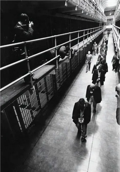  ?? AP PHOTO ?? Right: In this 1963 file photo, handcuffed prisoners prepare for transfer from the island prison that housed some of the nation’s most notorious criminals, including James “Whitey” Bulger and Al Capone.