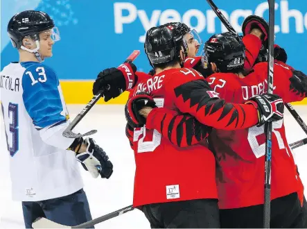  ?? LEAH HENNEL ?? Team Canada celebrates Montreal’s Maxim Noreau’s goal against Finland, the difference in a 1-0 victory.