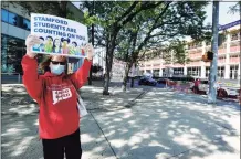  ?? Matthew Brown / Hearst Connecticu­t Media ?? Diane Phanos, president of Stamford teachers union, holds a sign in front of the Stamford Government Center on May 21, 2020, urging city officials to fund Stamford schools.