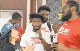  ?? COURTESY PHOTO ?? Sportscast­er Rachel Baribeau talks with Maryland football players about her mental health awareness program this week.