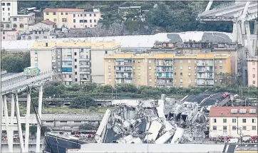  ?? ANTONIO CALANNI — THE ASSOCIATED PRESS ?? A view of the Morandi highway bridge after a section of it collapsed Tuesday in Genoa, Italy. Casualties were high.