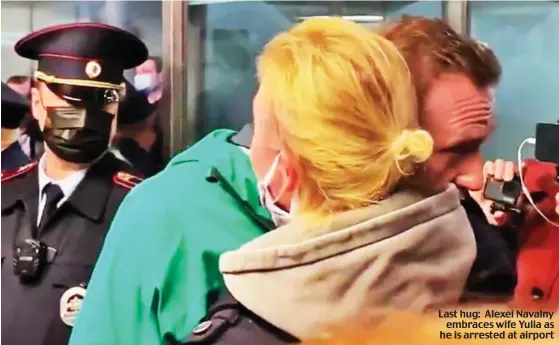 ??  ?? Last hug: Alexei Navalny embraces wife Yulia as he is arrested at airport