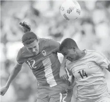  ?? THE ASSOCIATED PRESS ?? Canada’s Christine Sinclair, left, and Zimbabwe’s Eunice Chibanda jump for the ball in their game on Saturday.