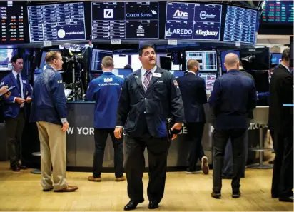  ?? (Brendan McDermid/Reuters) ?? TRADERS WORK on the floor of the New York Stock Exchange yesterday. MSCI’s world index, which tracks shares in 46 countries, was boosted by a higher open on Wall Street and rose 0.44%.