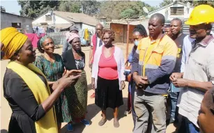  ?? Picture: Nicholas Bakili - ?? Industry and Commerce Minister Dr Sekai Nzenza (left) and Housing and Social Amenities Minister Daniel Garwe (right) engage Mbare residents during their tour of the suburb in Harare yesterday.