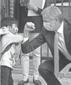  ?? TIMOTHY A. CLARY/AFP VIA GETTY IMAGES ?? New York City Mayor Bill de Blasio gives an elbow bump to 4-year old Oliver as he welcomes students to Mosaic Pre-K Center on Sept. 21.