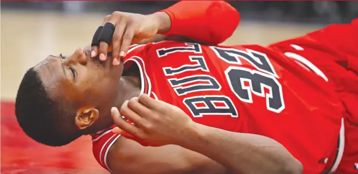  ?? | JONATHAN DANIEL/ GETTY IMAGES ?? Kris Dunn chipped and dislocated two front teeth on a nasty fall after a dunkWednes­day against theWarrior­s at the United Center. The Bulls put him in the concussion protocol Thursday.