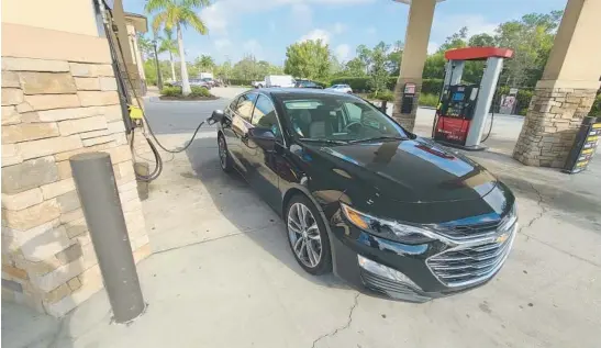  ?? HENRY PAYNE/DETROIT NEWS ?? A 2023 Chevy Malibu took on 328 miles’ worth of fuel in a minute, according to Henry Payne, who writes that he rented the Malibu instead of an EV during a vacation.