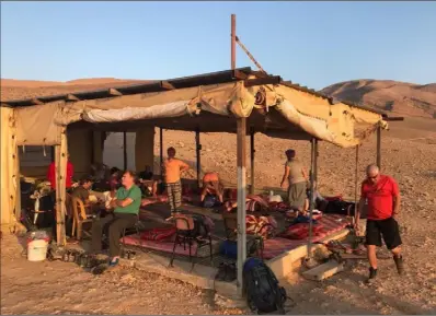  ??  ?? The travellers enjoying breakfast with a Bedouin family.