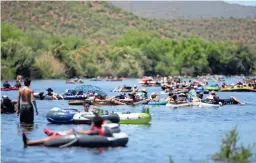  ?? THOMAS HAWTHORNE/THE REPUBLIC ?? Tubers float down the Salt River during the COVID-19 pandemic in Mesa on May 16, 2020.