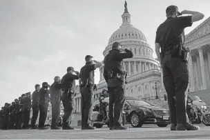  ?? JACQUELYN MARTIN/ASSOCIATED PRESS ?? U.S. Capitol Police officers salute as the casket of slain U.S. Capitol Police Officer William ‘Billy’ Evans leaves Tuesday in Washington.