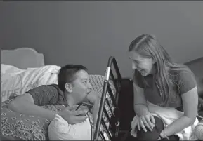  ?? SUN SENTINEL PHOTOGRAPH­S BY JOHN MCCALL ?? Kyle Laman laughs with friend Kellie Wanamaker at his home in Coral Springs, Fla. on Tuesday. Laman has undergone multiple surgeries to his foot due to a gun shot wound he received during the massacre at Marjory Stoneman Douglas High School on Feb. 14.