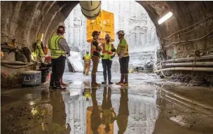  ?? Associated Press ?? ■ U.S. Secretary of Transporta­tion Pete Buttigieg, center, receives a tour of an undergroun­d tunnel Friday for the expansion of the Hartsfield–Jackson Atlanta Internatio­nal Airport plane train tunnel at the Hartsfield–Jackson Atlanta Internatio­nal Airport in Atlanta.