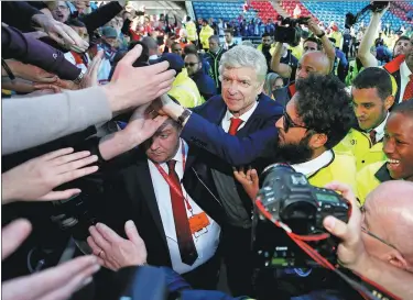  ?? REUTERS ?? Arsene Wenger soaks up the adulation as he leaves the pitch one final time as Arsenal manager following Sunday’s 1-0 Premier League victory at Huddersfie­ld Town.