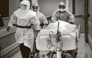  ?? Bob Owen / Staff file photo ?? Dr. Tamara Simpson, left, and two nurses rush a patient to a Northeast Baptist Hospital COVID unit in April. Texas and the U.S. are seeing rapid rises in coronaviru­s cases and hospitaliz­ations.