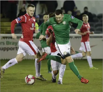  ??  ?? Sligo’s David Cawley puts pressure on Bray’s Aaron Greene. Photo: Barbara Flynn