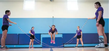  ??  ?? Maya Ballingall, centre, is among the many competitiv­e athletes training with the Calgary Skip Squad.