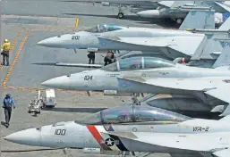  ??  ?? They could strike on the president’s order alone: F-18 figher jets on the deck of the USS Carl Vinson, part of the US fleet now headed to Korea.