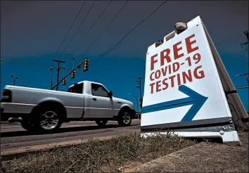  ?? ERIC GAY/AP ?? Coronaviru­s testing in Texas has dipped significan­tly, mirroring a nationwide trend. Above, a truck passes a sign for free COVID-19 testing Friday in San Antonio.