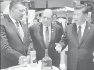  ??  ?? Prime Minister Andrew Holness (left) with Chinese President Xi Jingping at the 2019 China Internatio­nal Import Expo being held in Shanghai, China, on Tuesday, November 5. Also present is Industry and Commerce Minister Audley Shaw (centre).