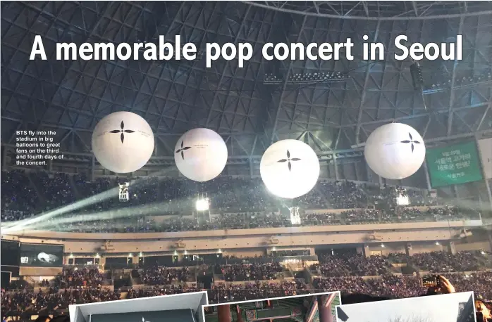  ??  ?? BTS fly into the stadium in big balloons to greet fans on the third and fourth days of the concert.