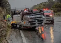  ?? Bobby Block/The Signal ?? Officials with the Los Angeles County Fire Department respond to a vehicle rollover on Sierra Highway Monday afternoon.