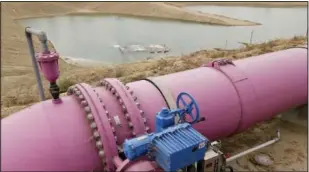  ?? (File Photo/AP/Chris Carlson) ?? A pipe feeds recycled wastewater to a holding pond to recharge an undergroun­d aquifer May 6, 2016, at the Orange County Water District recharge facility in Anaheim, Calif.