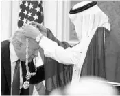  ?? EVAN VUCCI/ASSOCIATED PRESS ?? Salman presents the Collar of Abdulaziz Al Saud to Trump on Saturday in Riyadh.