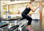  ??  ?? Physical therapist Chelsea Holt demonstrat­es a single let sit to stand exercise.