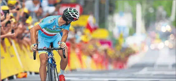  ??  ?? ON THE LOOKOUT: Current champion Vincenzo Nibali checks behind him after crossing the finish line ahead of the chasing pack