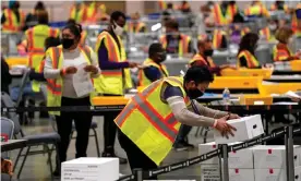  ?? Photograph: The Washington Post/Getty Images ?? Election workers extract mail-in ballots in a secure room at the Pennsylvan­ia convention center in Philadelph­ia on 3 November.