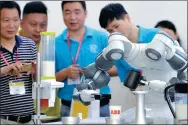  ?? ZHOU CHAO / FOR CHINA DAILY ?? YuMi, a robot produced by ABB, makes coffee for visitors at a fair in Wuhan, Hubei province.