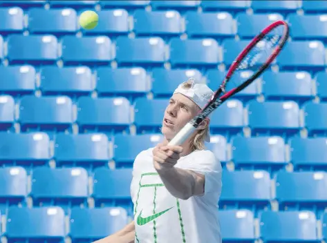  ?? PHOTOS: PAUL CHIASSON/THE CANADIAN PRESS ?? Denis Shapovalov returns a ball while training in Montreal on Thursday ahead of the U.S. Open.
