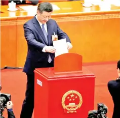  ??  ?? File photo shows Xi dropping his ballot, during a vote on a constituti­onal amendment lifting presidenti­al term limits, at the third plenary session of the National People’s Congress at the Great Hall of the People in Beijing. — Reuters photo