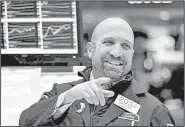  ?? AP/RICHARD DREW ?? Specialist James Denaro works on the floor of the New York Stock Exchange on Monday, when stocks rallied and the market clawed back some of its big losses from last week. The Dow Jones industrial­s climbed 410 points.