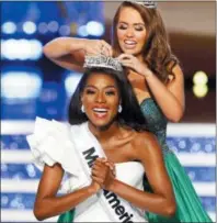  ?? NOAH K. MURRAY — THE ASSOCIATED PRESS ?? Miss New York Nia Franklin reacts after being named Miss America 2019, as she is crowned by last year’s winner Cara Mund, Sunday in Atlantic City, N.J.