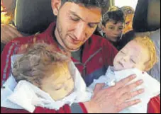  ?? AP FILE ?? Not another one: AbdulHamid Alyousef holds his twin babies who were killed during a suspected chemical weapons attack in Syria’s Khan Sheikhoun in April.