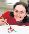  ??  ?? Organiser Kate Furey working on the Poppy banner created at Accrington Market Hall