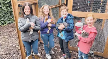  ?? TERRYCHEA/AP ?? Members of the Abta family — Allison, from left, Violet, Eli and Ariella — hold hens in front of their backyard chicken coop in Ross, California.