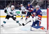  ?? BRUCE BENNETT — GETTY IMAGES ?? The Islanders’ Ilya Sorokin (30) with the third period chest save as the Sharks’ Logan Couture (39) looks for the rebound at UBS Arena on Thursday in Elmont, New York.